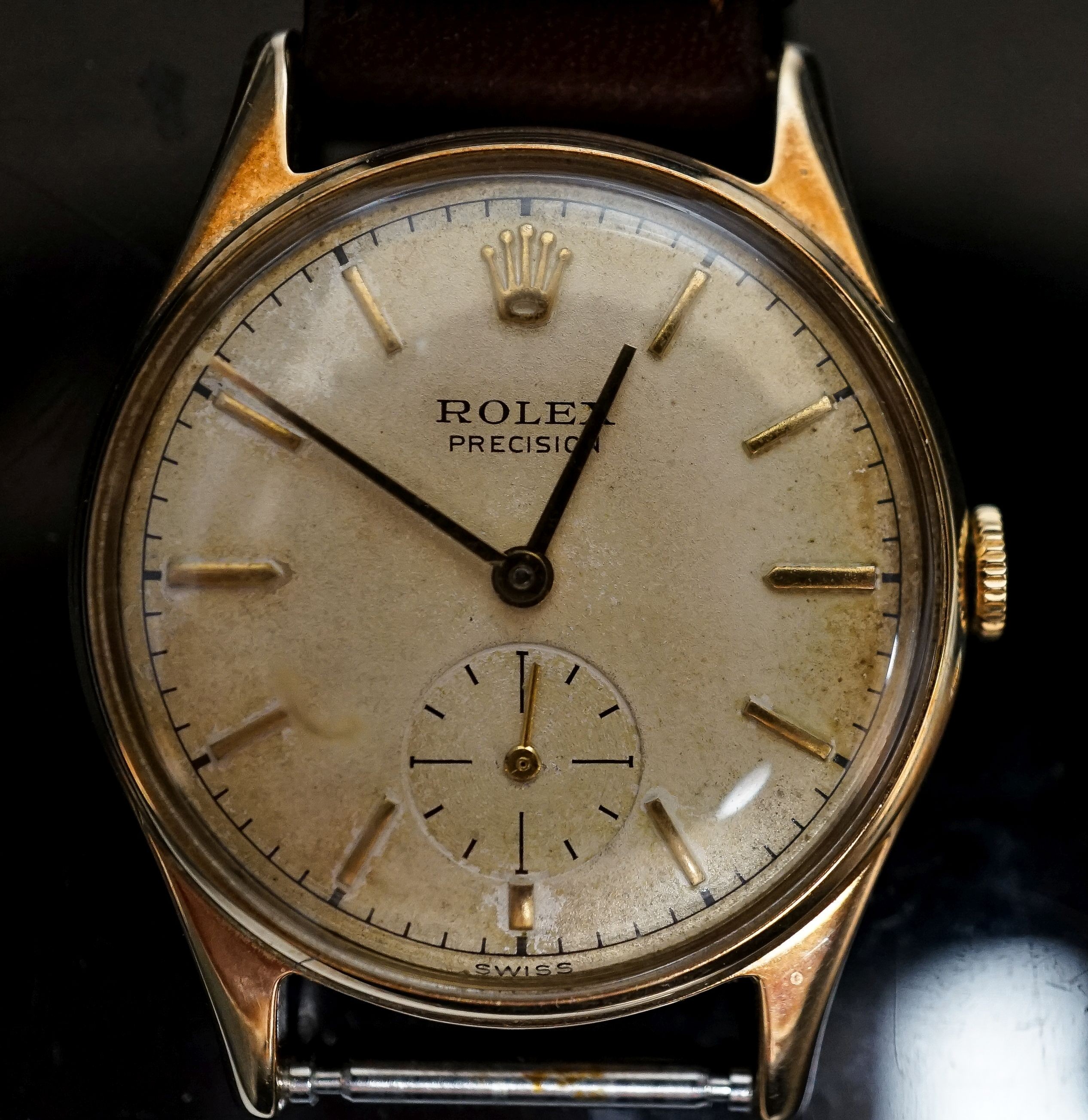 A gentleman's late 1950's 9ct gold Rolex Precision, manual wind wrist watch, on associated leather strap, with box and purchase receipt dated 3/8/1959, cased diameter 31mm, gross weight 28.5 grams, part of strap detached